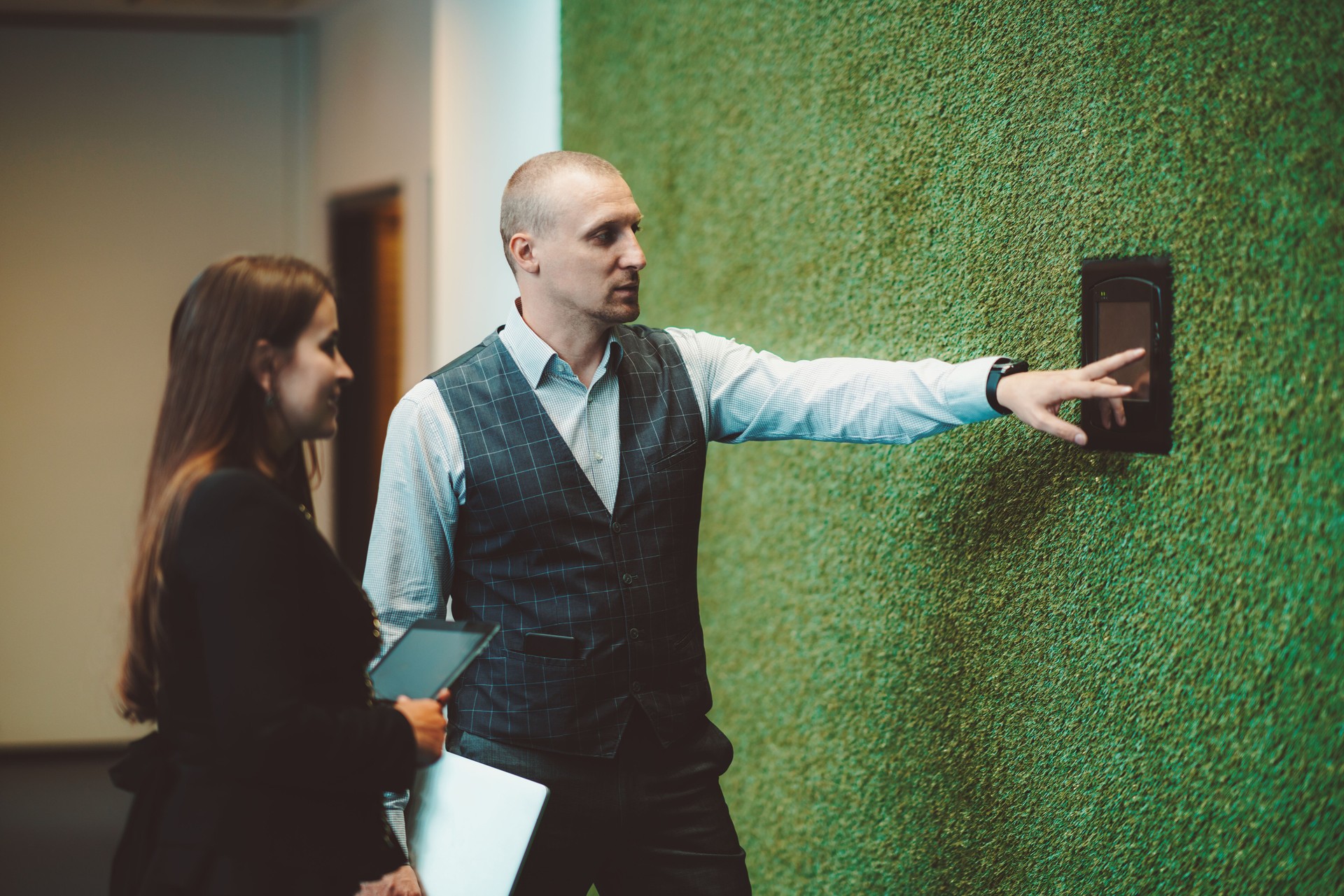 Couple using a terminal on the wall