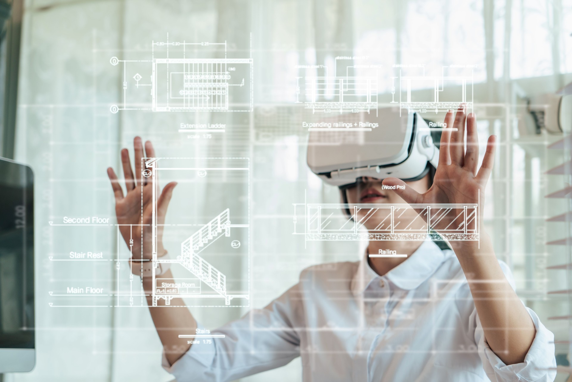 Asian woman Architect or Engineer wearing VR headset for hologram blueprint detail working with BIM technology.
