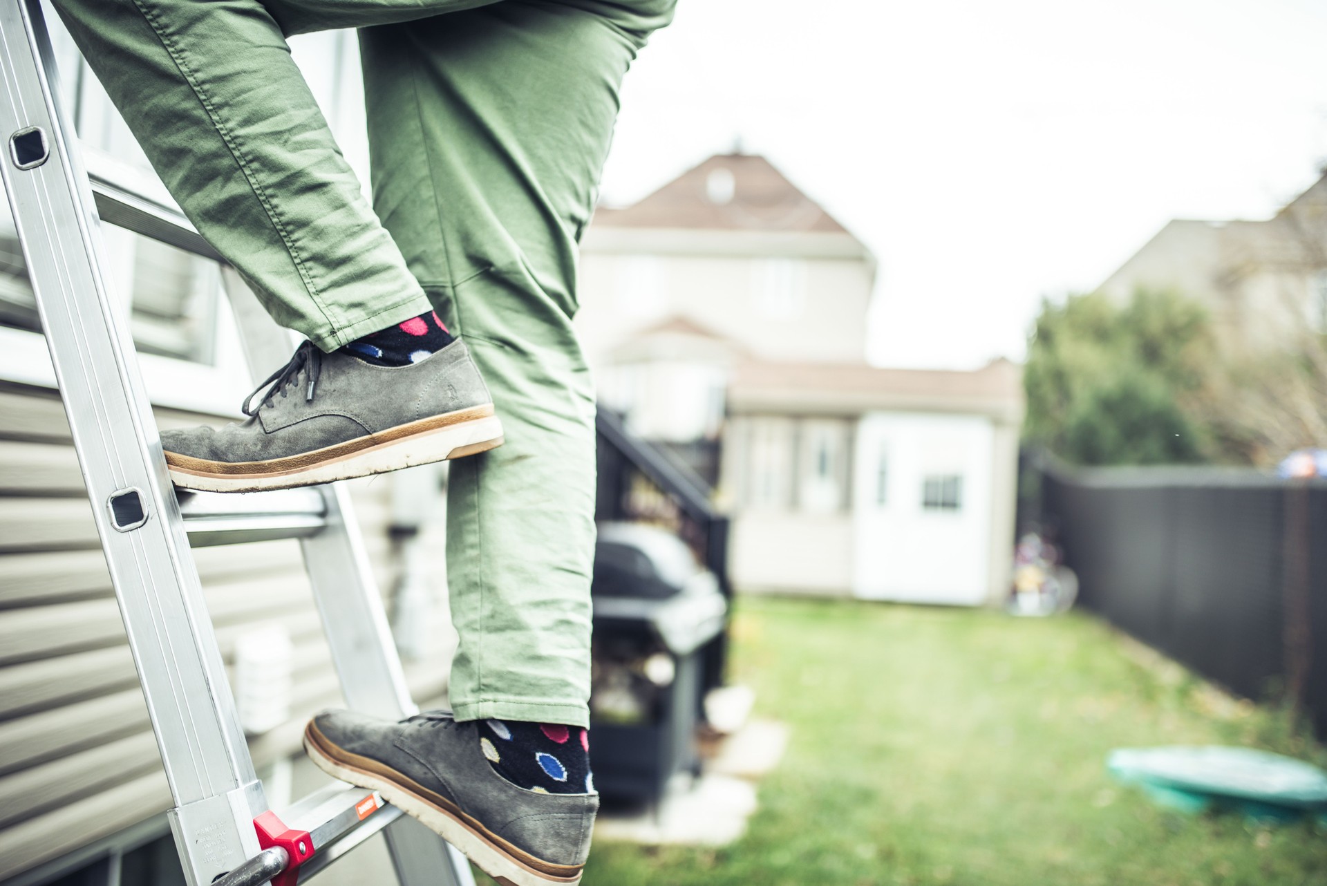 House owner climbing the ladder to inspect the house
