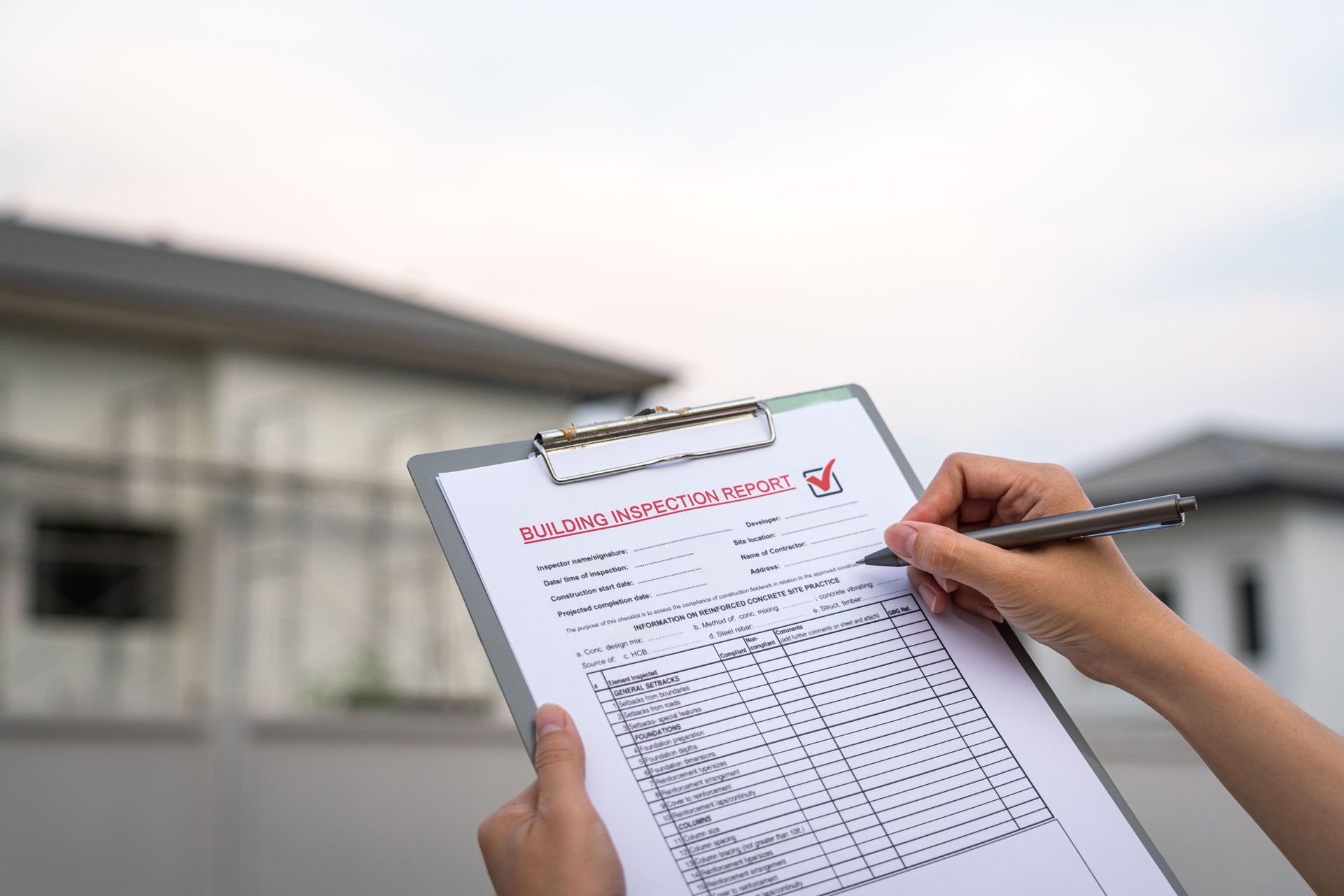 Inspecting building house on the report form.